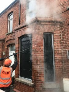 Steam cleaning brick façade