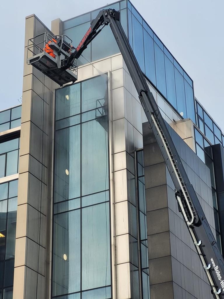 PMAC operatives cleaning Office building from a hoist