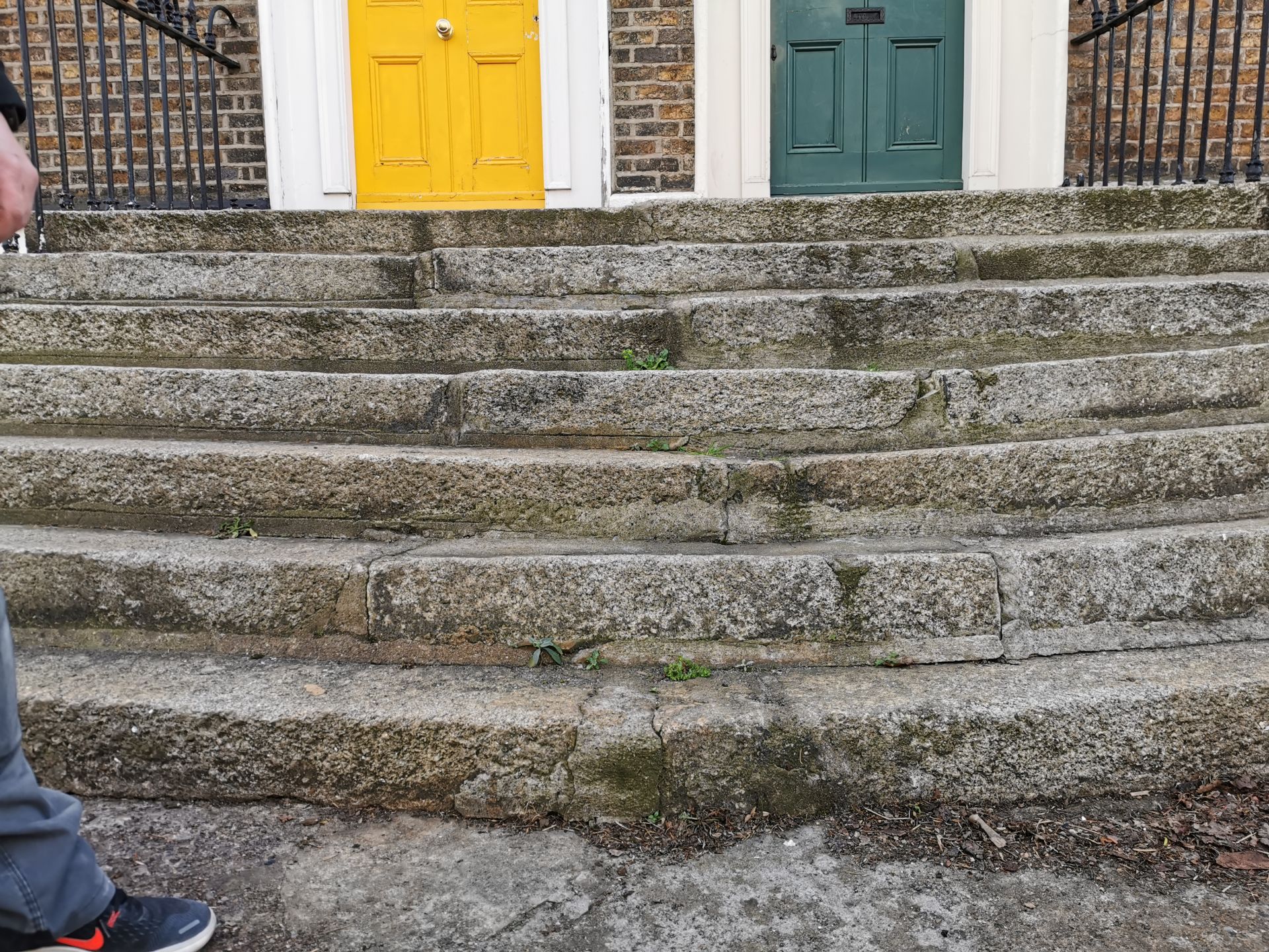 Front view of granite steps showing cracks and missing mortar