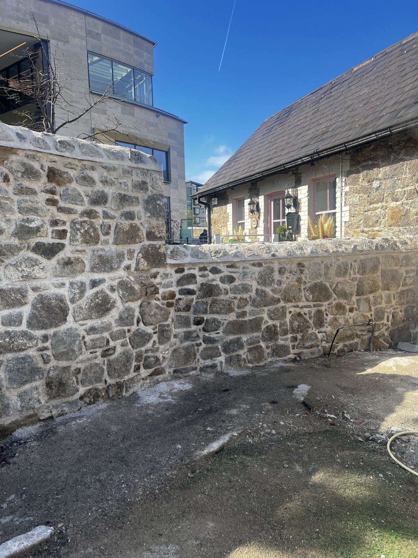 Wall A, fully rebuilt and repointed using traditional methods.