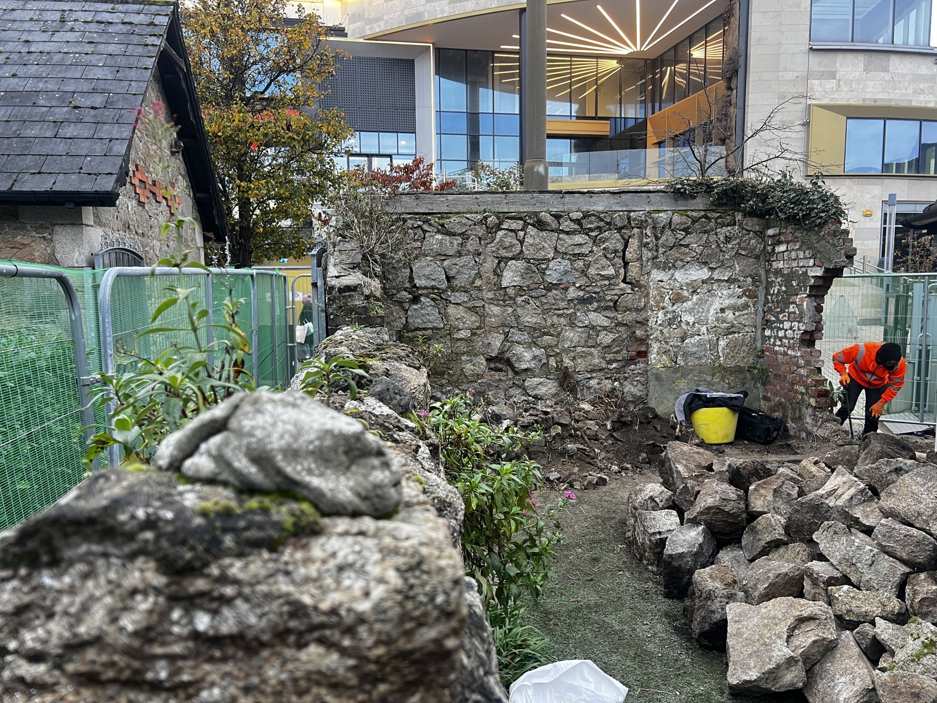 Salvaged granite stones to be recycled into the restored wall