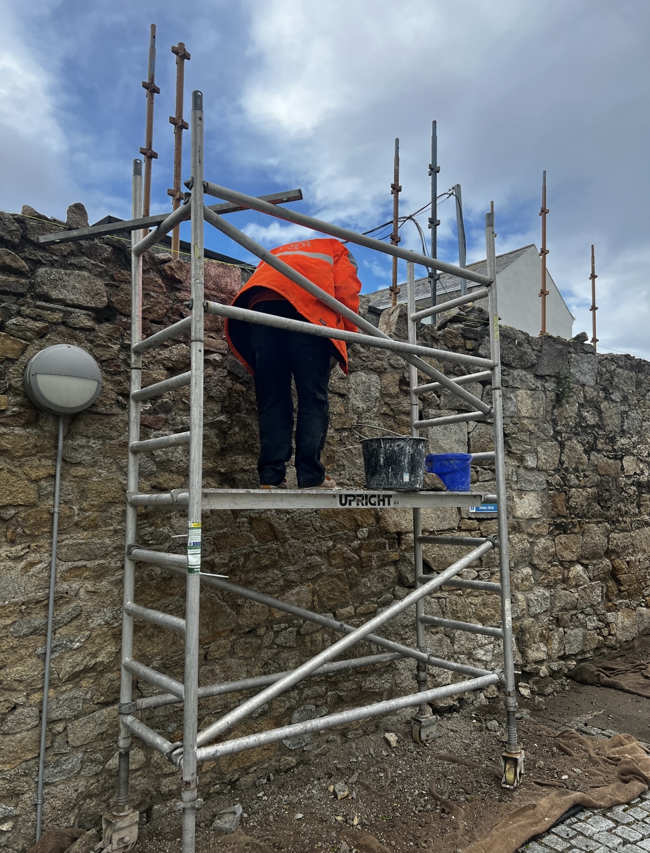 Skilled PMAC craftsman mending Parochial Garden Wall