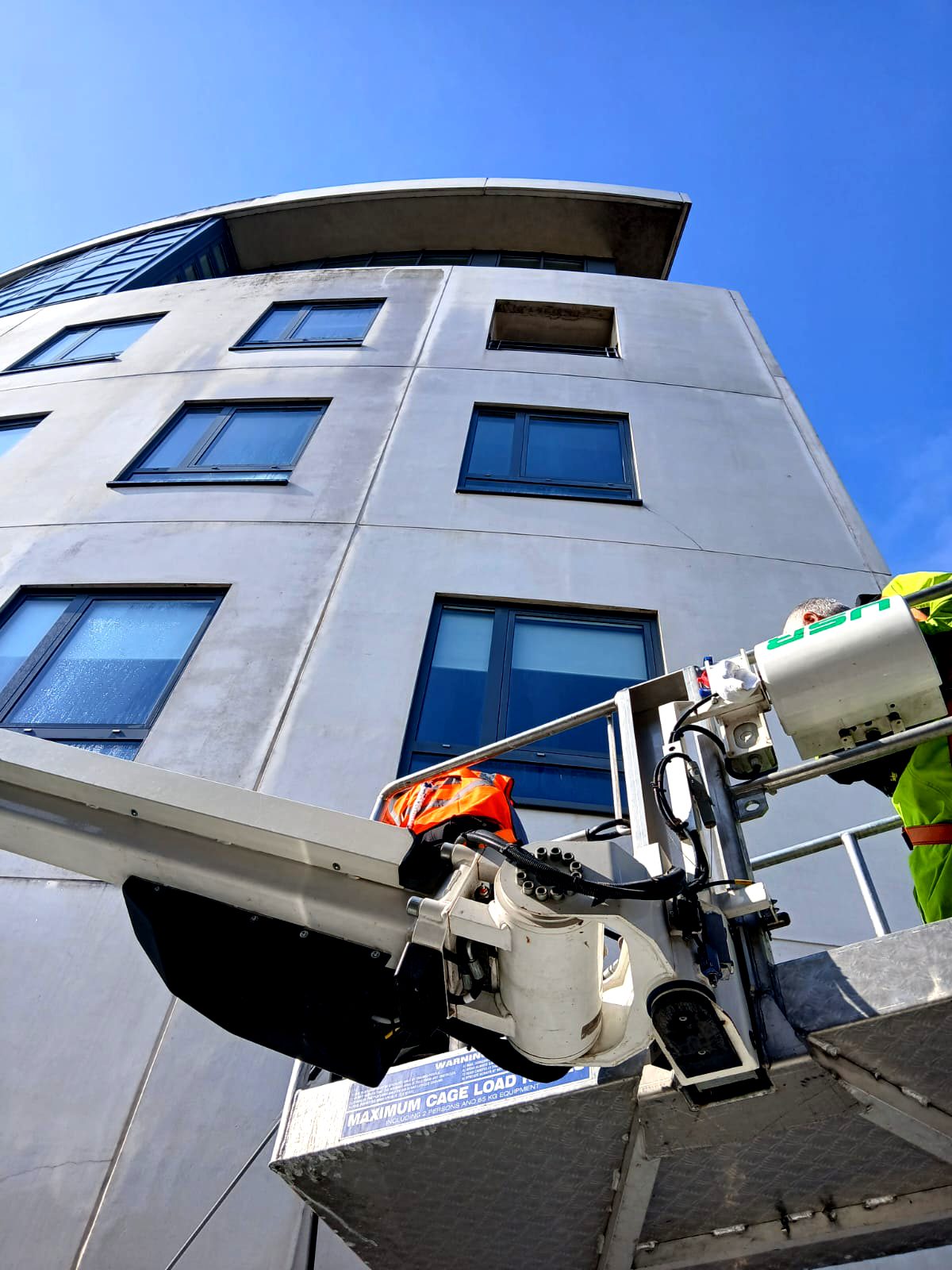 MEWP assisting in the cleaning of a high rise techrete facade